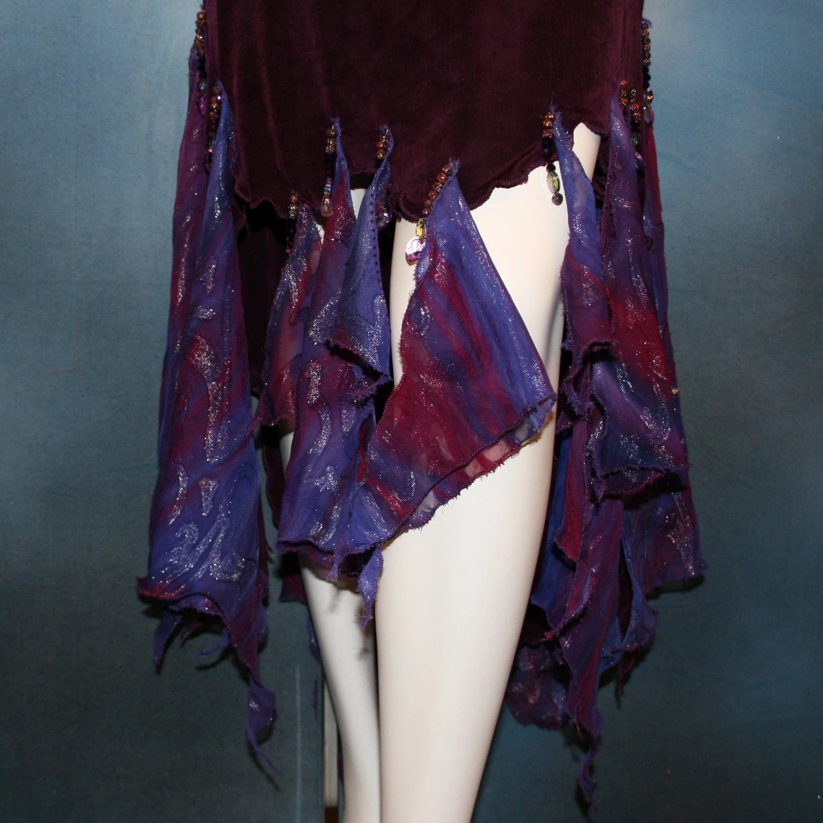 front lower view of Social ballroom dance dress created in luxurious wine solid slinky fabric with flounces of deep scarlette & wine printed & dazzling chiffon, with Swarovski hand beading. A great social dress for any ballroom dance or special occasion, as well as a great beginner ballroom dance show dress!