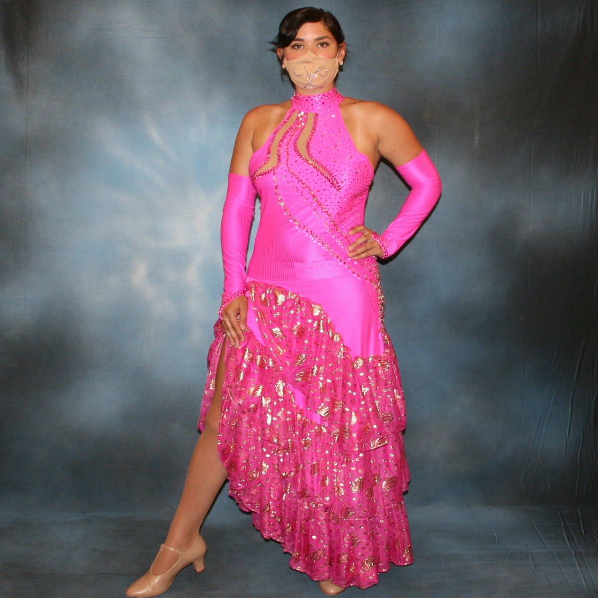 Crystal's Creations Fuchsia tango dress created of textured fuchsia lycra with ruffles of gold leafed patterned chiffon, nude illusion cutouts & low back, is embellished with gold aurum Swarovski rhinestone work & hand beading.
