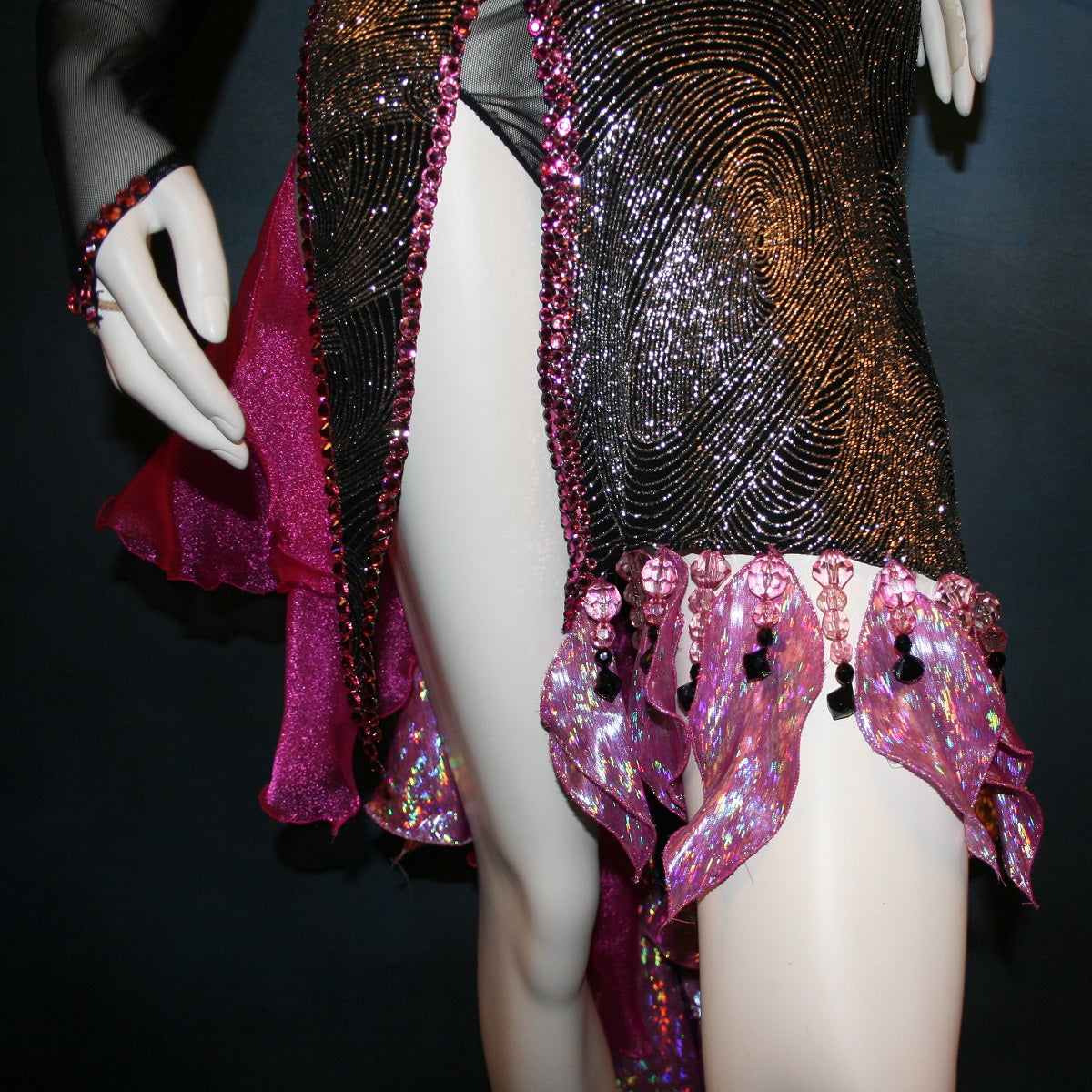 Crystal's Creations bottom front details of Black & silver Latin/rhythm dress with pink accents created of gorgeous silver swirls on black glitter slinky on a sheer stretch mesh base, embellished with pink Swarovski rhinestone work & hand beading