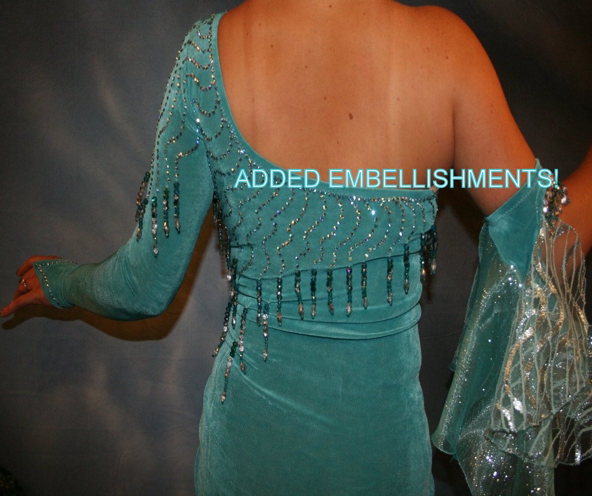 Upper back view of Crystal's Creations aqua Latin/rhythm dress created in aqua luxurious solid slinky with glitter organza flounces, aqua Swarovski rhinestone work, now with added hand beading, arm embellishment & more flounces