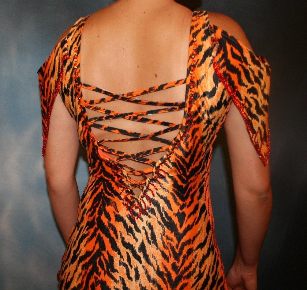 Crystal's Creations close up back view of Tiger print & orange Latin/rhythm dress created of tiger print lycra & luxurious orange solid slinky has color blocking, lattice work detailing in front bodice, split sides & low back, as well as intriguing longer back skirting, adorned with orange chandelle feathers, also features detailed Swarovski rhinestone work!