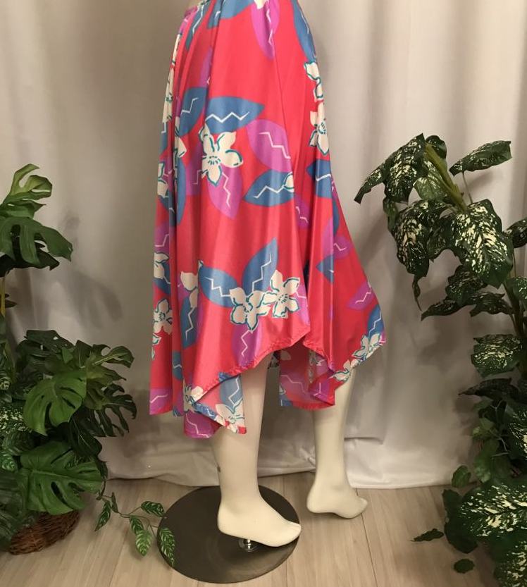 side view of dance skirt Made of a vibrant deep pink and blue tropical print lycra, this mid-calf skirt is designed with a fullness that flows beautifully on the dance floor. Perfect for tropical theme parties,