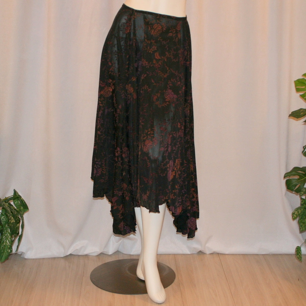 Black velveteen ballroom skirt with a gorgeous floral pattern, it creates a delightful swirl of autumn colors with its gored seaming and abundant fullness, and elasticized waist for ease of fit. Deep scalloped hemline adds a touch of charm, perfect for any ballroom event, studio dance parties, practice, or teaching!