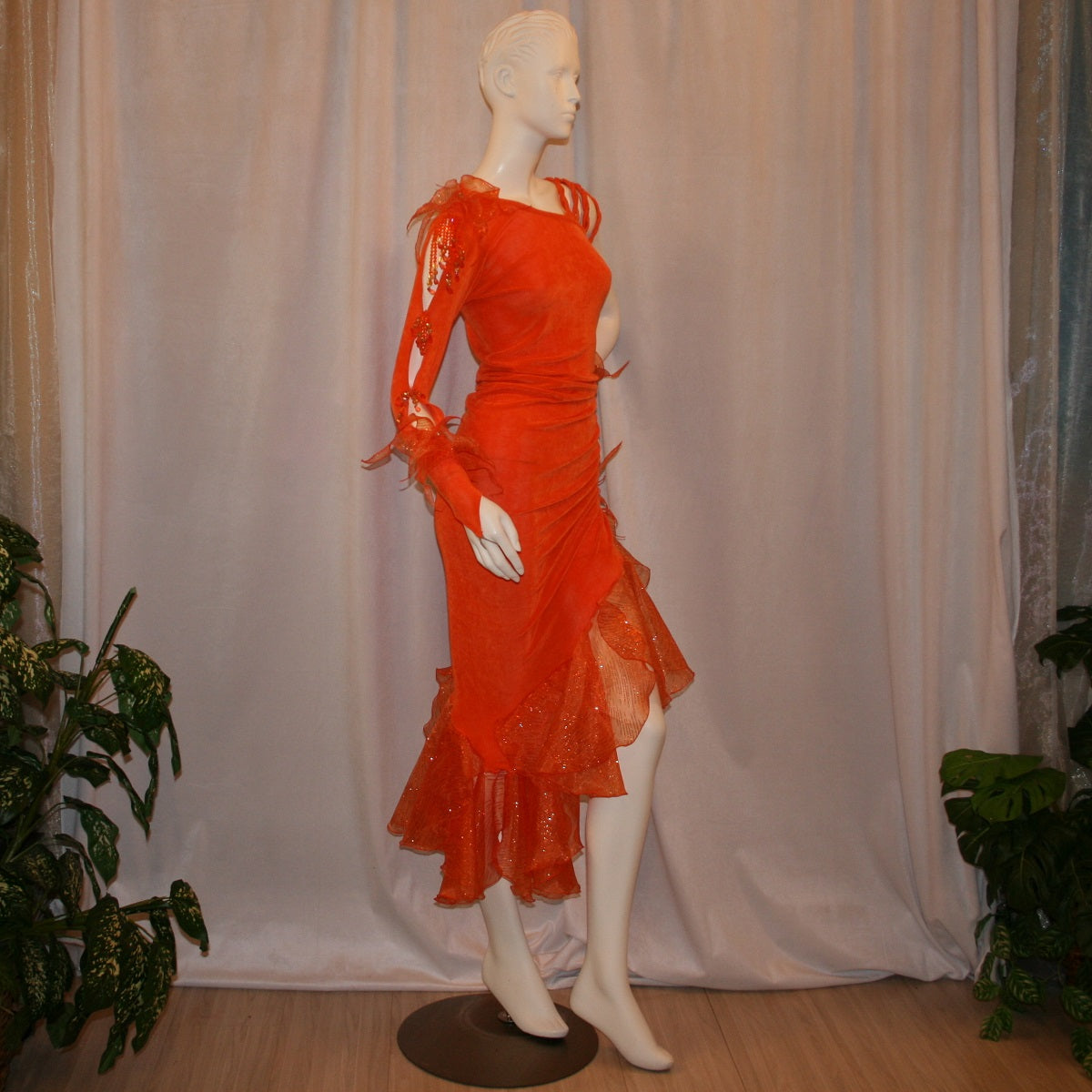 Crystal's Creations right side view of Orange Latin/rhythm dress was created in luxurious orange solid slinky with oodles of glitter organza flounces & accents, embellished with a touch of Swarovski hand beading.