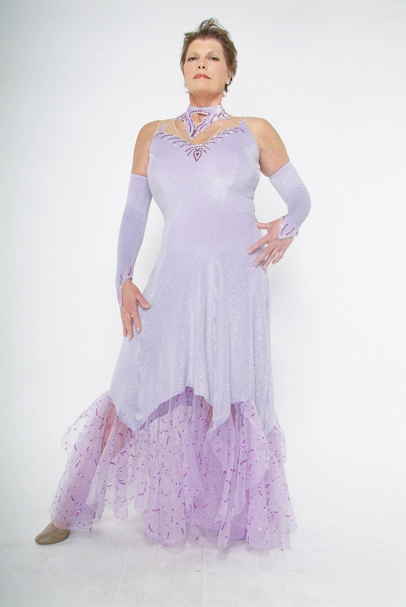 Crystal's Creations Luxurious orchid ballroom dress was created in glitter velvet on nude illusion base, flairs out to sheer organza with sequined skirting. embellished with fuschia & CAB Swarovski rhinestone work.