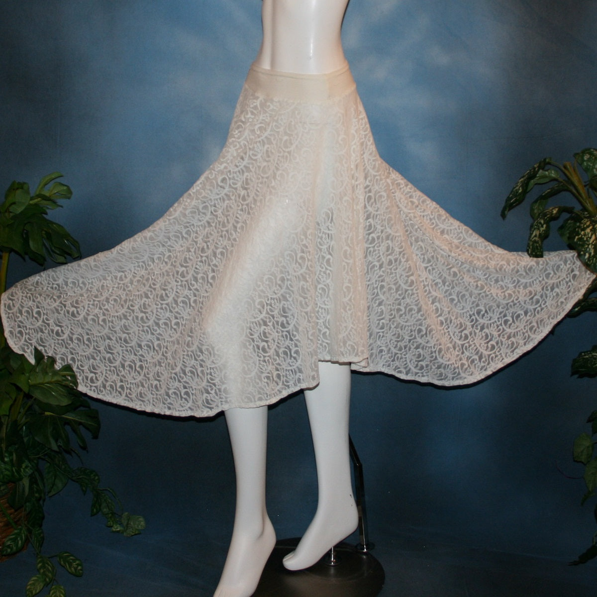 Full side flared view of white ballroom skirt crafted from stunning stretch lace features an extra full, waltzing length design and is slightly shorter on the sides.