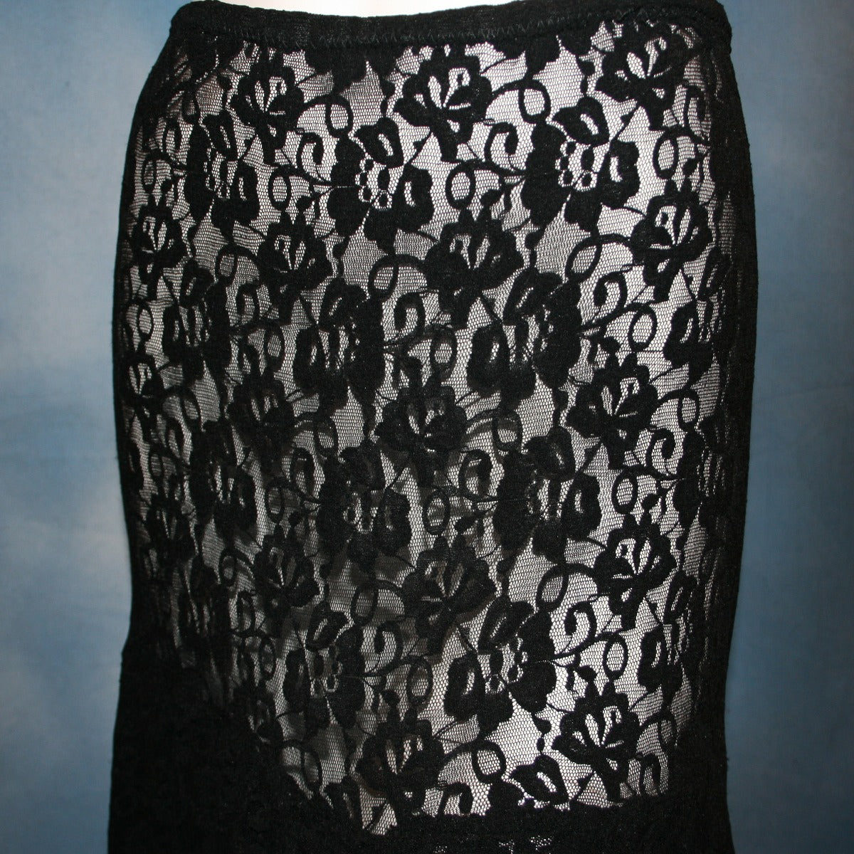 close view of Black lace Latin/rhythm skirt, 2 tier style, was created with yards of back stretch lace, with 2 full circles cut with sides higher, back longer on a hip base.