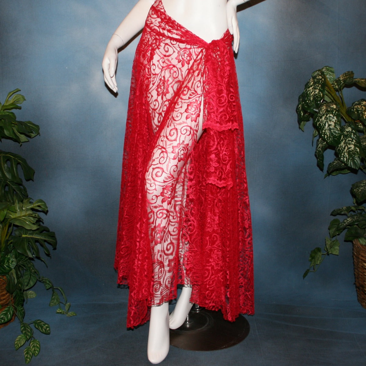 Red lace ballroom skirt, wrap style, was created with yards of red lace, many panels shaped like large petals.