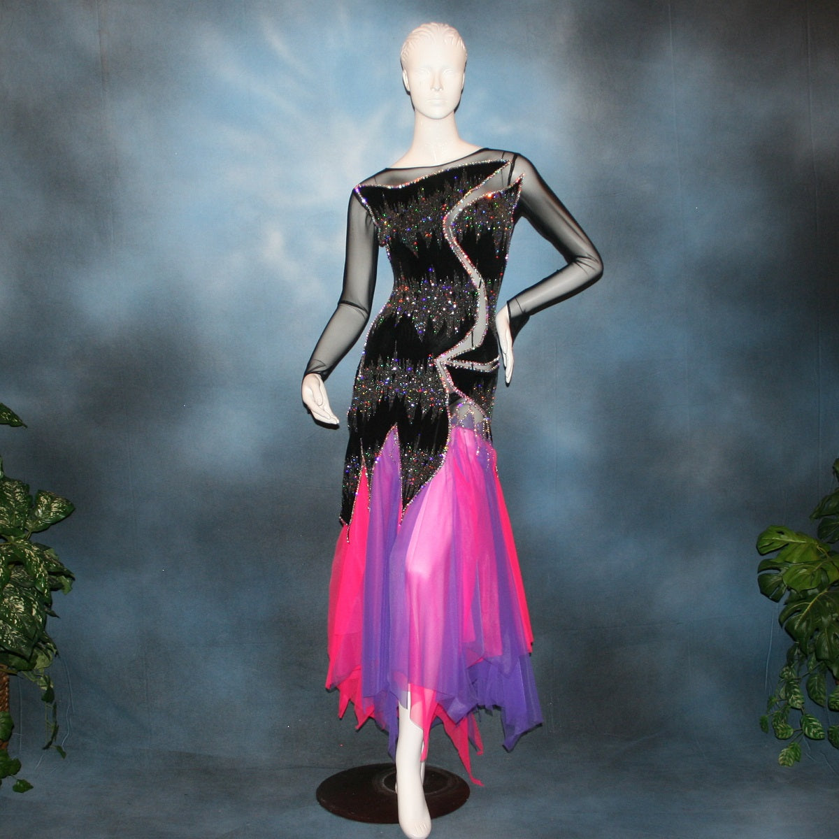 Crystal's Creations purple & pink underskirt with Latin/rhythm/converta ballroom dress created in black glitter slinky with an awesome electrifying Crystal AB glitter pattern artistically placed on a black stretch mesh base, embellished with Swarovski Crystal AB rhinestone work. It includes 3 skirts so you have 4 different looks for versatility.