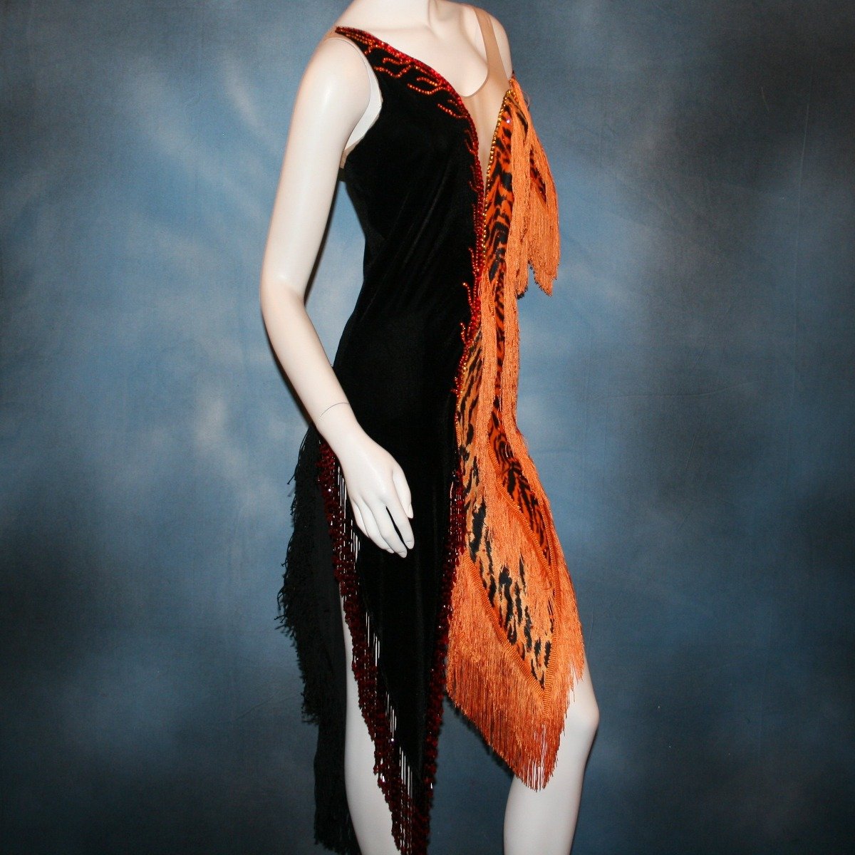 Crystal's Creations side close up view of orange & black tiger print Latin/rhythm dress with fringe