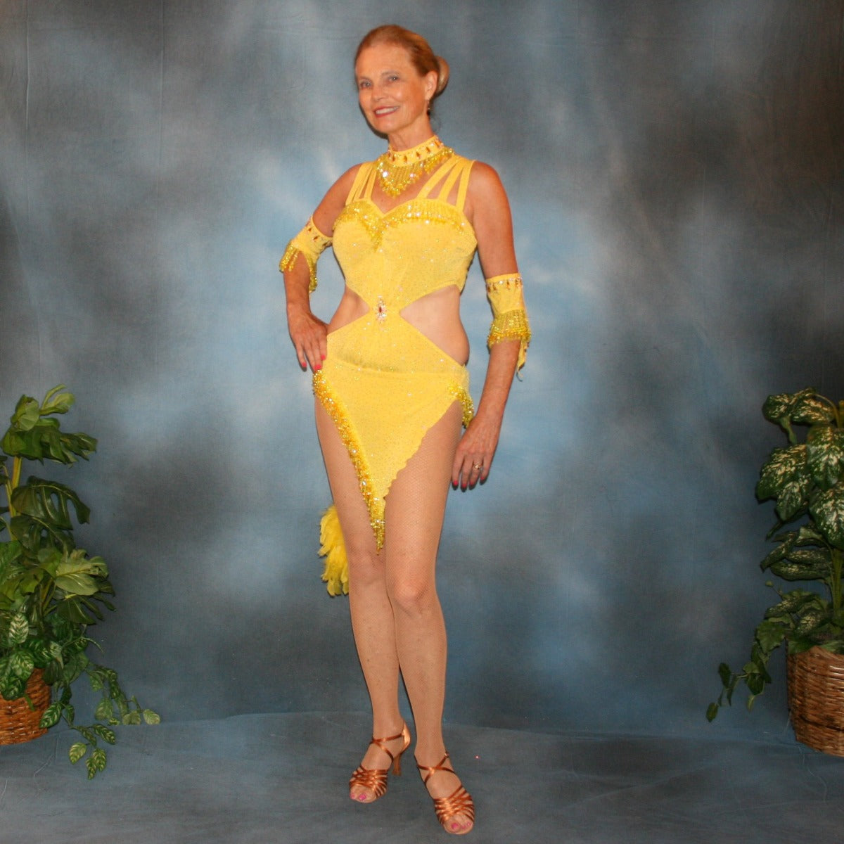 Crystal's Creations Yellow Latin/rhythm dress created of yellow glitter slinky features hand beaded fringe, cut out midriff sides, CAB Swarovski rhinestone work & a touch of turkey feathers.