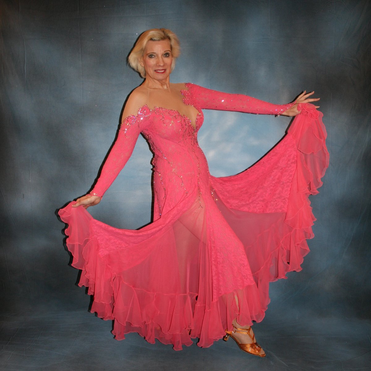 Crystal's Creations side view of Gorgeous salmon pink ballroom dance dress was created from salmon pink stretch lace on nude illusion base with yards & yards of salmon pink chiffon insets & flounces …