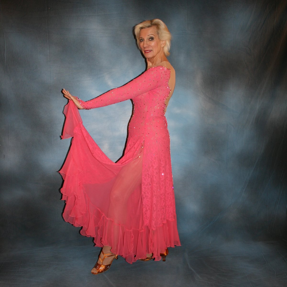 Crystal's Creations left side view of Gorgeous salmon pink ballroom dance dress was created from salmon pink stretch lace on nude illusion base with yards & yards of salmon pink chiffon insets & flounces …
