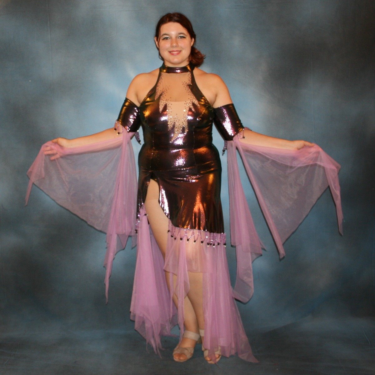 Crystal's Creations Metallic deep orchid/purple theatrical ballroom dress created in deep orchid/purple metallic lycra with orchid tricot chiffon panel skirt & floats, embellished with orchid Swarovski rhinestone work in bodice, along with hand beading at skirt edge & arm bands.