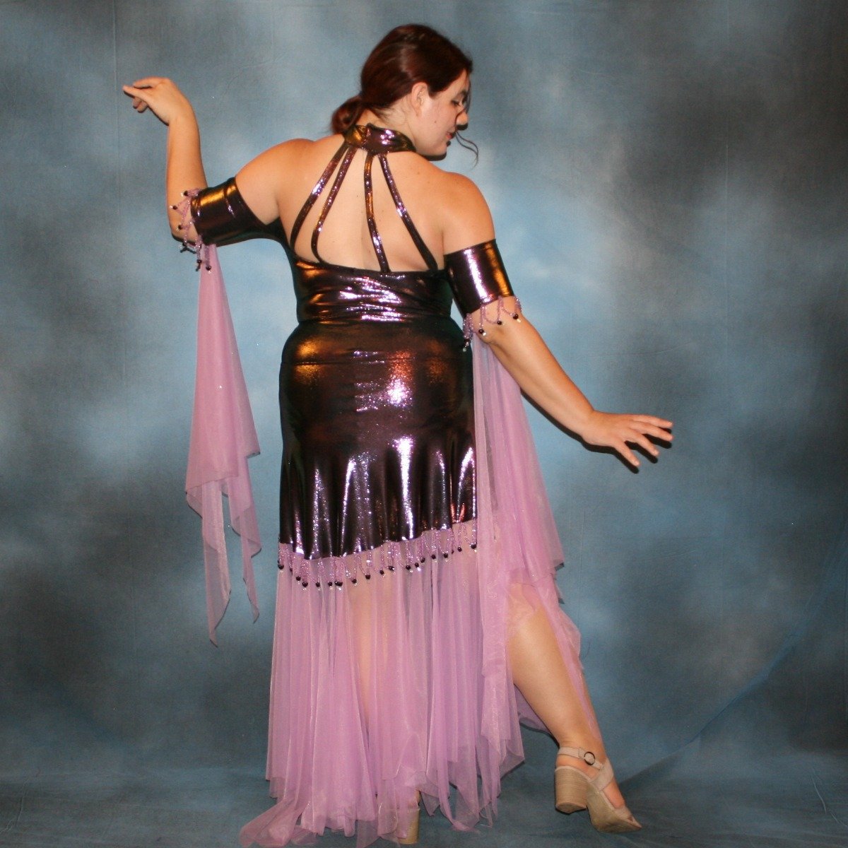Crystal's Creations back view of  Metallic deep orchid/purple theatrical ballroom dress created in deep orchid/purple metallic lycra with orchid tricot chiffon panel skirt & floats, embellished with orchid Swarovski rhinestone work in bodice, along with hand beading at skirt edge & arm bands.
