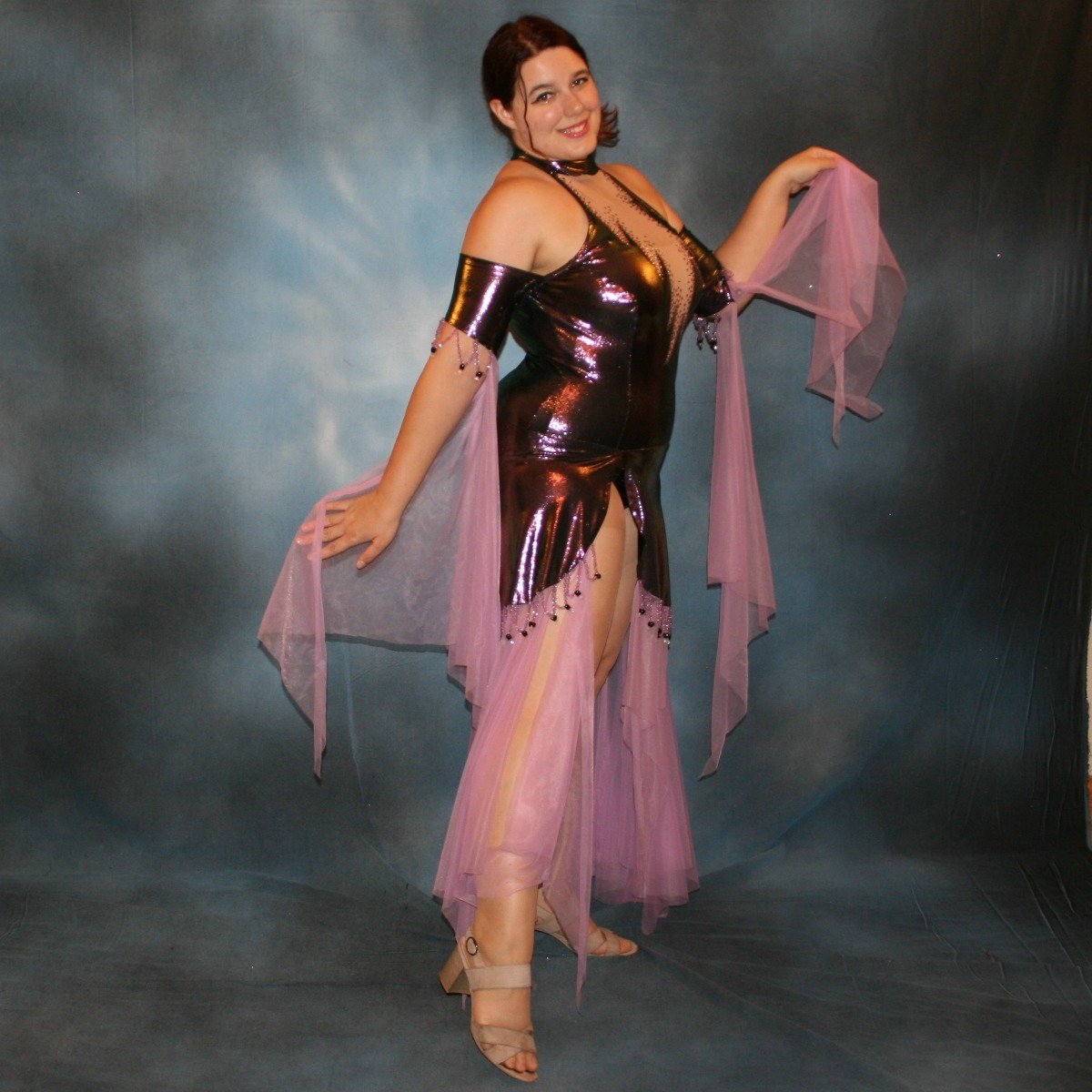 Crystal's Creations side view of  Metallic deep orchid/purple theatrical ballroom dress created in deep orchid/purple metallic lycra with orchid tricot chiffon panel skirt & floats, embellished with orchid Swarovski rhinestone work in bodice, along with hand beading at skirt edge & arm bands.