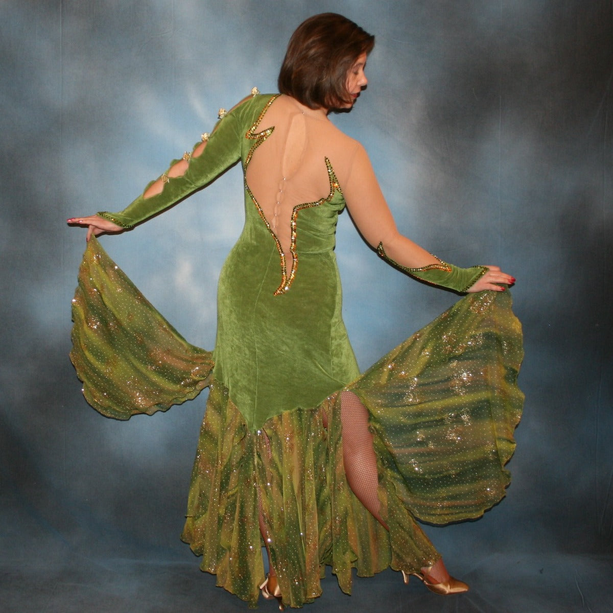Crystal's Creations back view of Green ballroom dress created of luxurious olive green solid slinky on nude illusion base with glitter chiffon print flounces of olive greens & gold… embellished with olivine, jonquil & peach Swarovski rhinestones.