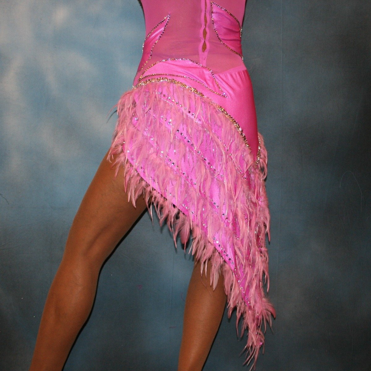 Crystal's Creations bottom back view of Orchid Latin/rhythm dress created in orchid lycra on an orchid sheer mesh base with detailed applique work, embellished with Swarovski rhinestone work in crystal vitrail light, along with orchid feather fringe.