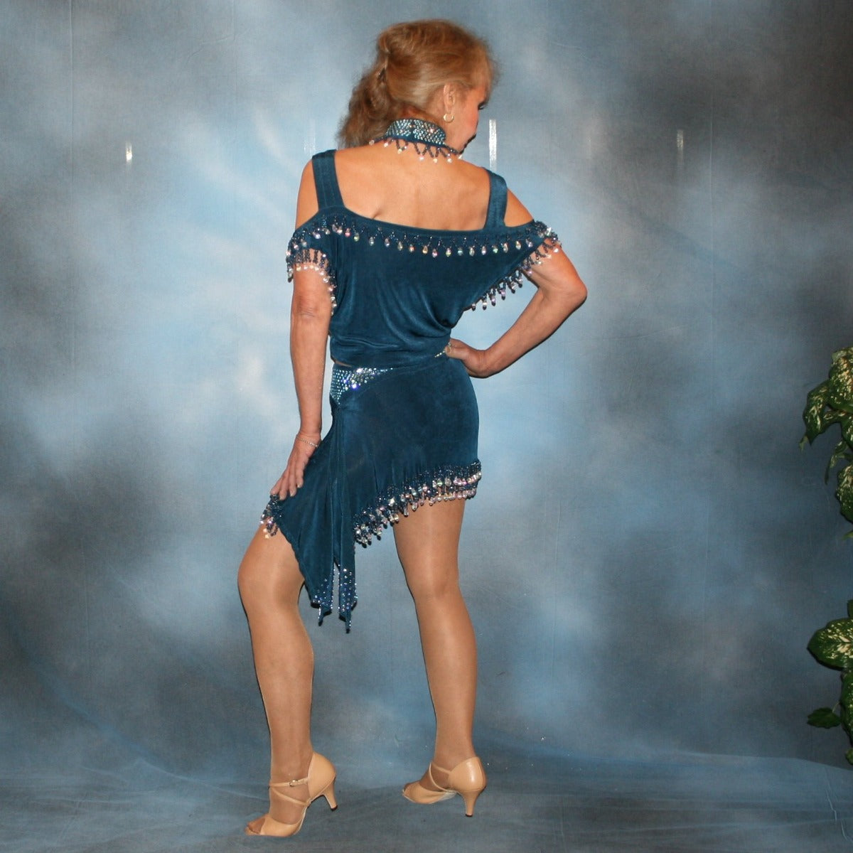 Crystal's Creations back view of  2 piece blue Latin/rhythm dance dress was created of deep sea blue luxurious solid slinky with cascades of hand beaded fringe plus light sapphire Swarovski rhinestone work. The Latin dance skirt has built in tights.