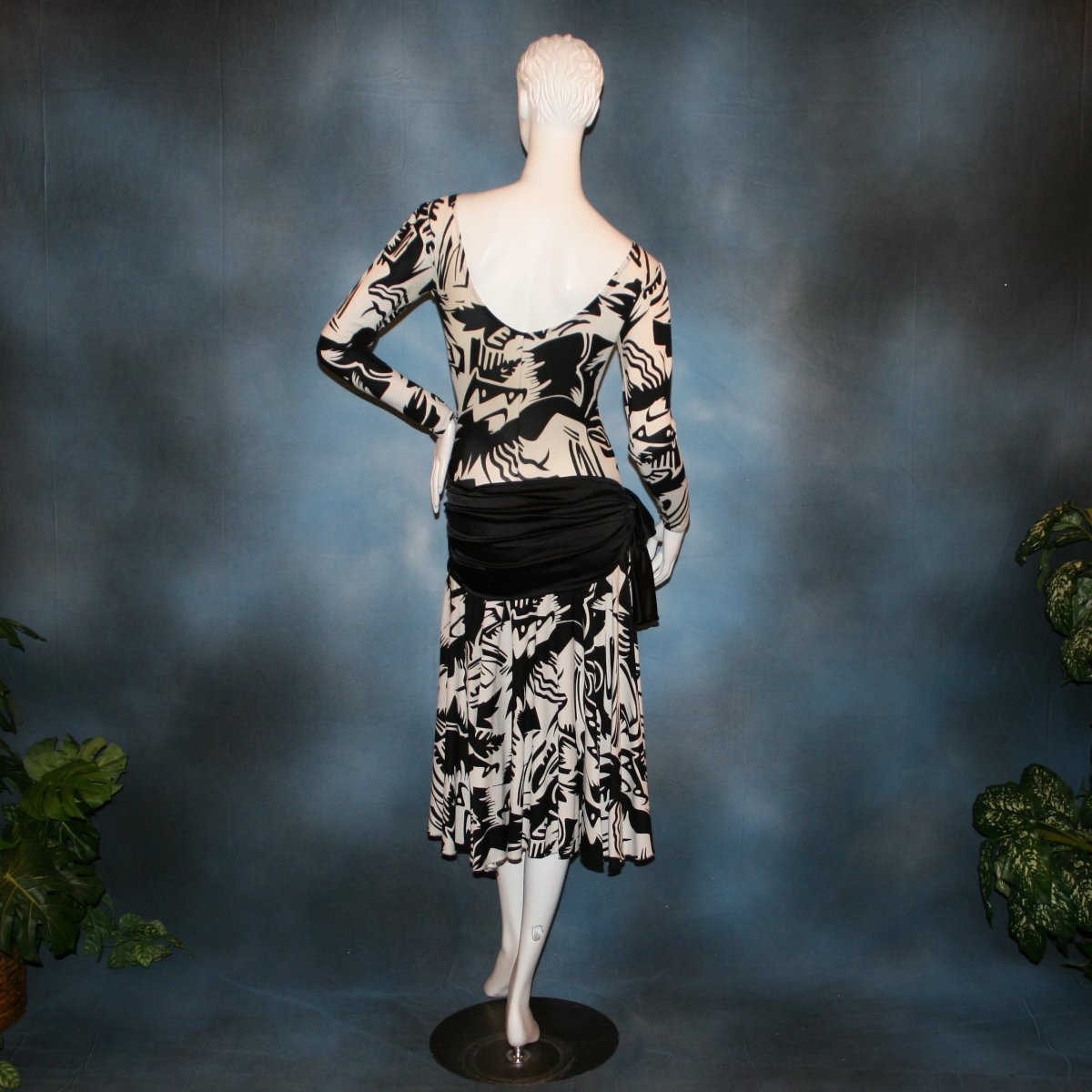 back view of Black & white tropical print lycra dress with solid black hip sash. Bodysuit base, so a great dress for Latin/rhythm dance practice or ballroom teachers!