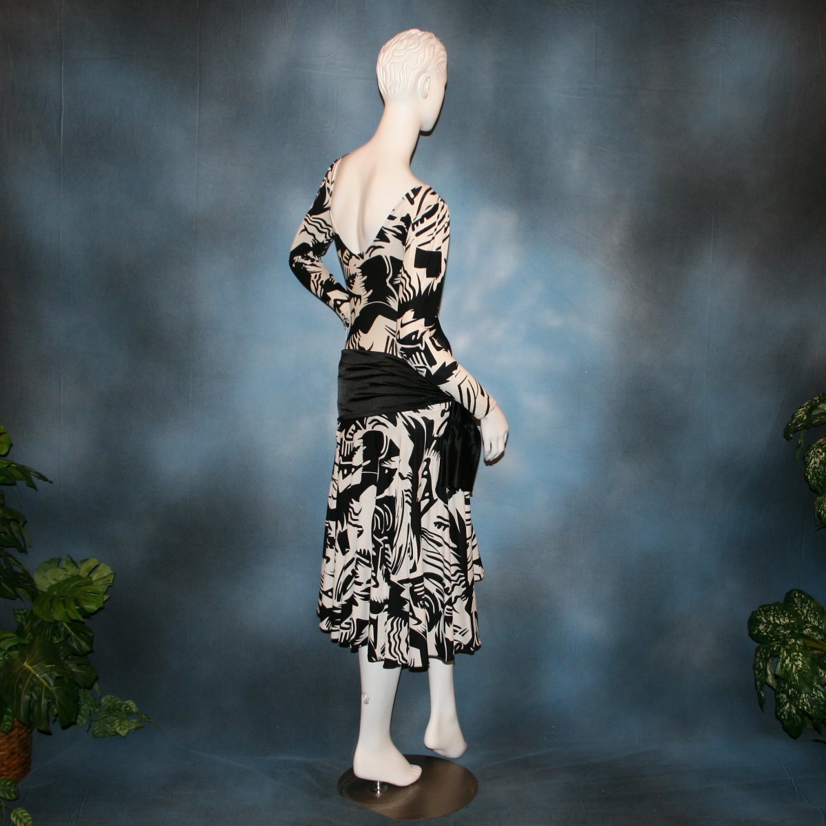 side back view of Black & white tropical print lycra dress with solid black hip sash. Bodysuit base, so a great dress for Latin/rhythm dance practice or ballroom teachers!