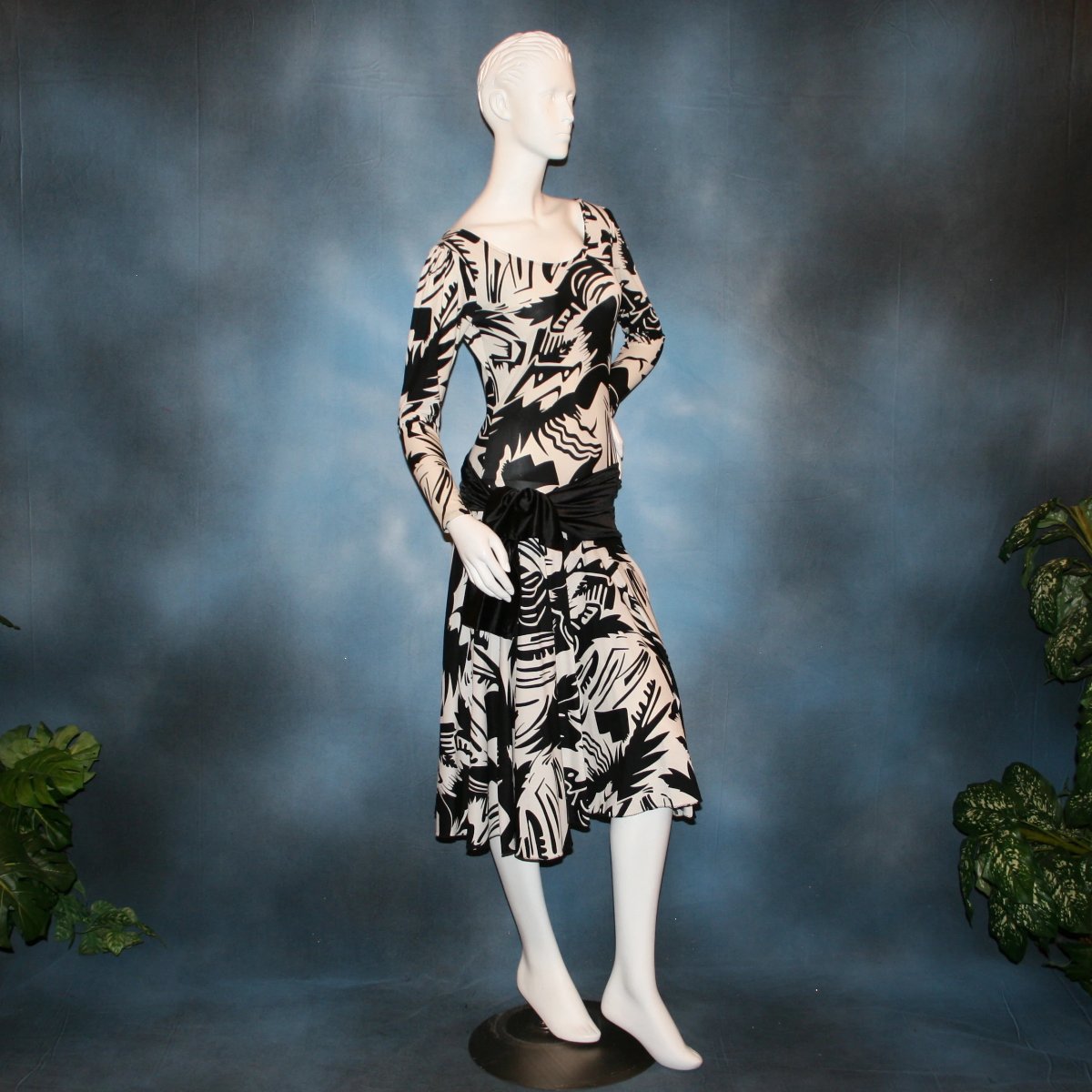 side view of Black & white tropical print lycra dress with solid black hip sash. Bodysuit base, so a great dress for Latin/rhythm dance practice or ballroom teachers!