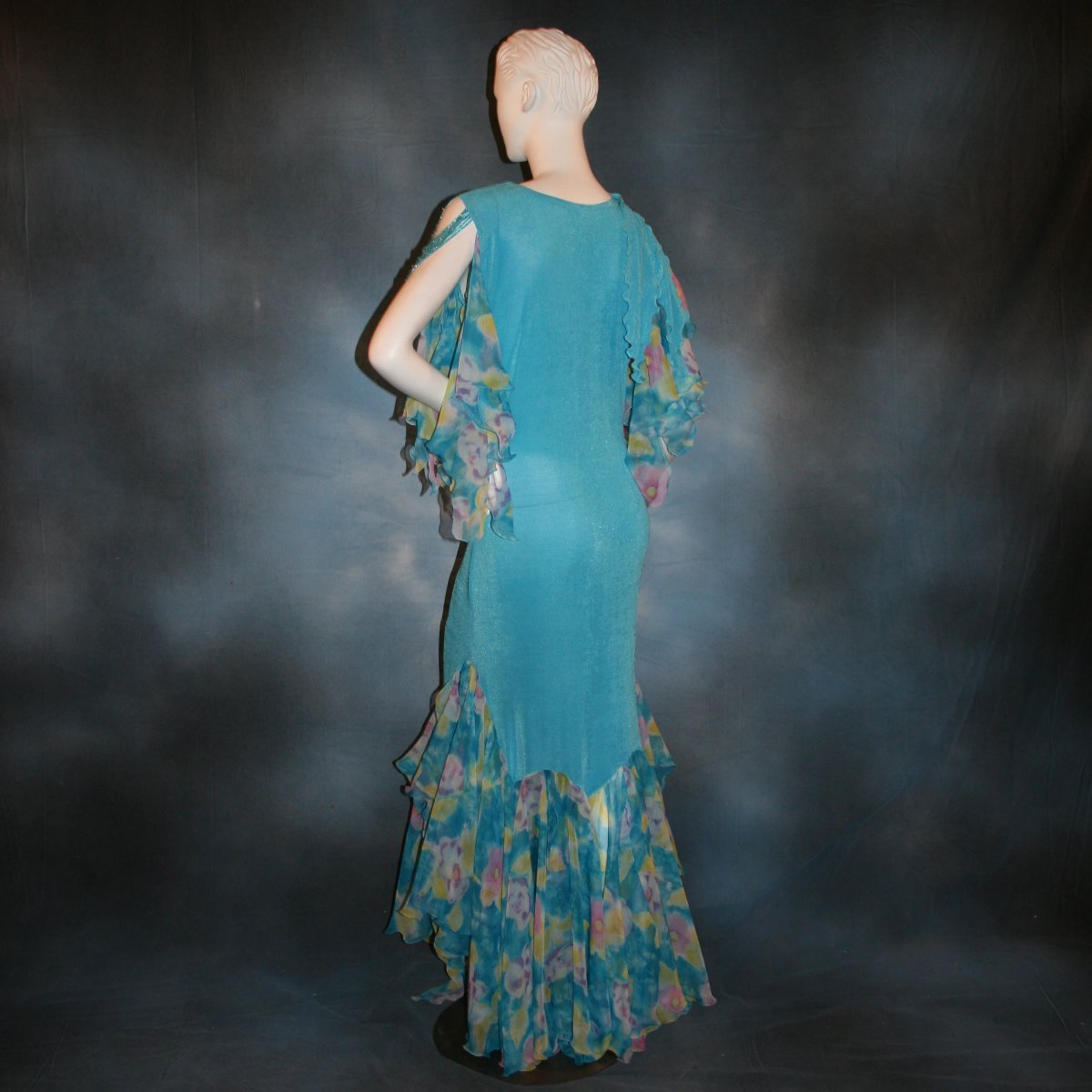 back view of Blue social ballroom dress of luxurious robin egg blue slinky, print chiffon flounces & floats with touches of orchid & yellow, embellished with Swarovski hand beading, is lovely for any ballroom dance or special occasion, and a fabulous beginner ballroom dancer show dress!
