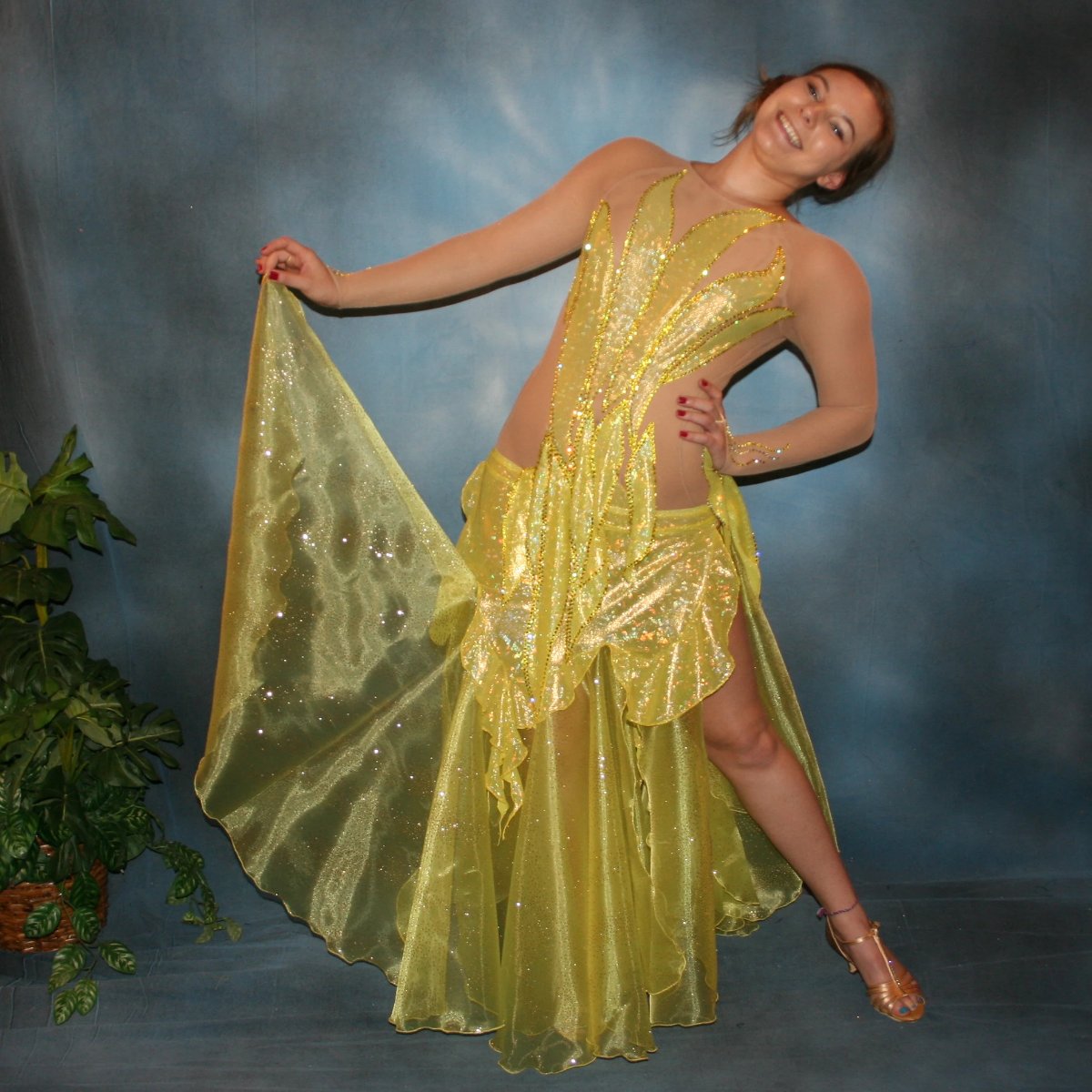 Crystal's Creations Yellow converta ballroom dress consisists of Latin/rhythm dress created of yellow hologram lycra overlayed artistically on nude  illusion base,  with handcut petal appliques on nude illusion base,embellished with citrine & jonquil ab Swarovski rhinestones, with converta skirt of yards of glittered organza.