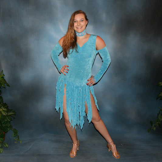 Crystal's Creations Turquoise Latin/rhythm dress was created in turquoise slinky glitterknit, has interesting strap detailing on the back, embellished with CAB Swarovski rhinestone work on the neck piece, & includes wrist bands or gauntlets with Swarovski rhinestone work.