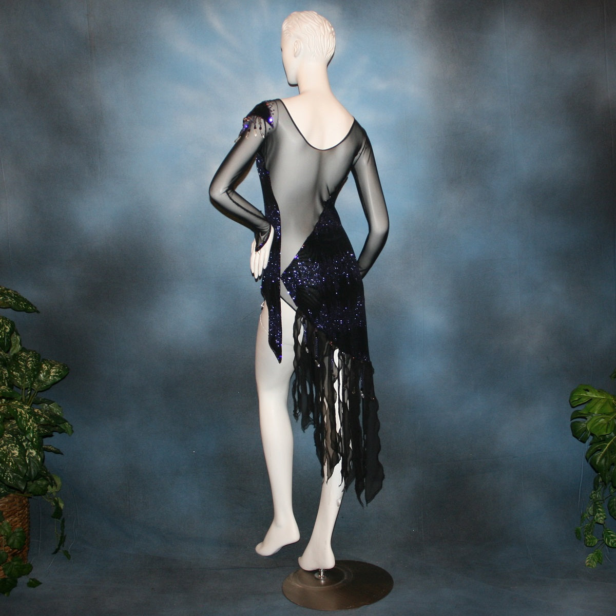 back view of Crystal's Creations Latin/rhythm/tango dress created in black glitter slinky with an awesome electrifying tanzanite/perwinkle glitter pattern artistically placed on a black stretch mesh base