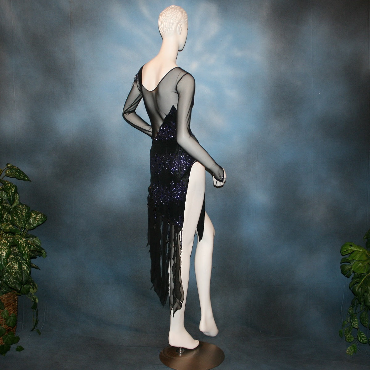 right back view of Crystal's Creations Latin/rhythm/tango dress created in black glitter slinky with an awesome electrifying tanzanite/perwinkle glitter pattern artistically placed on a black stretch mesh base