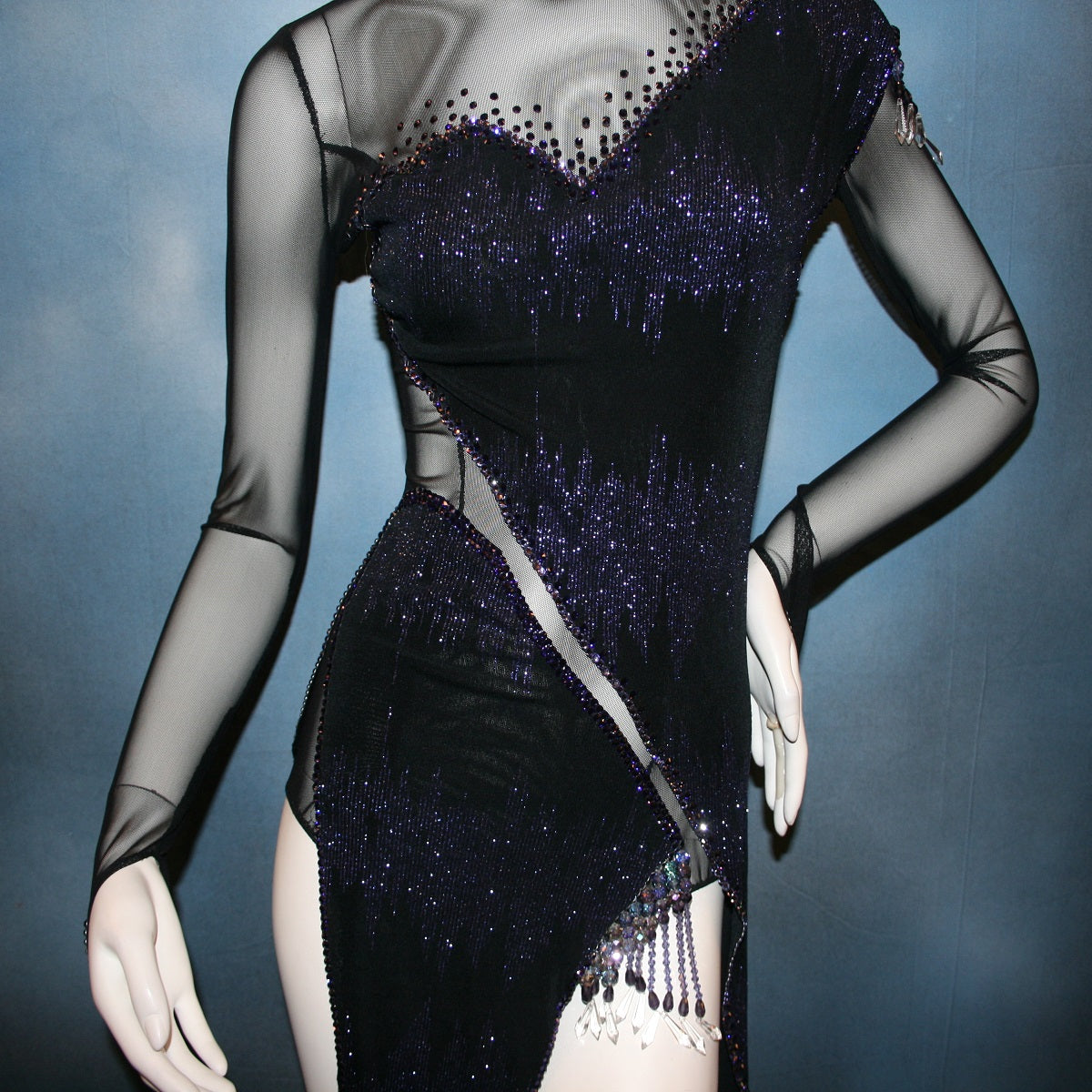 close up view of Crystal's Creations Latin/rhythm/tango dress created in black glitter slinky with an awesome electrifying tanzanite/perwinkle glitter pattern artistically placed on a black stretch mesh base