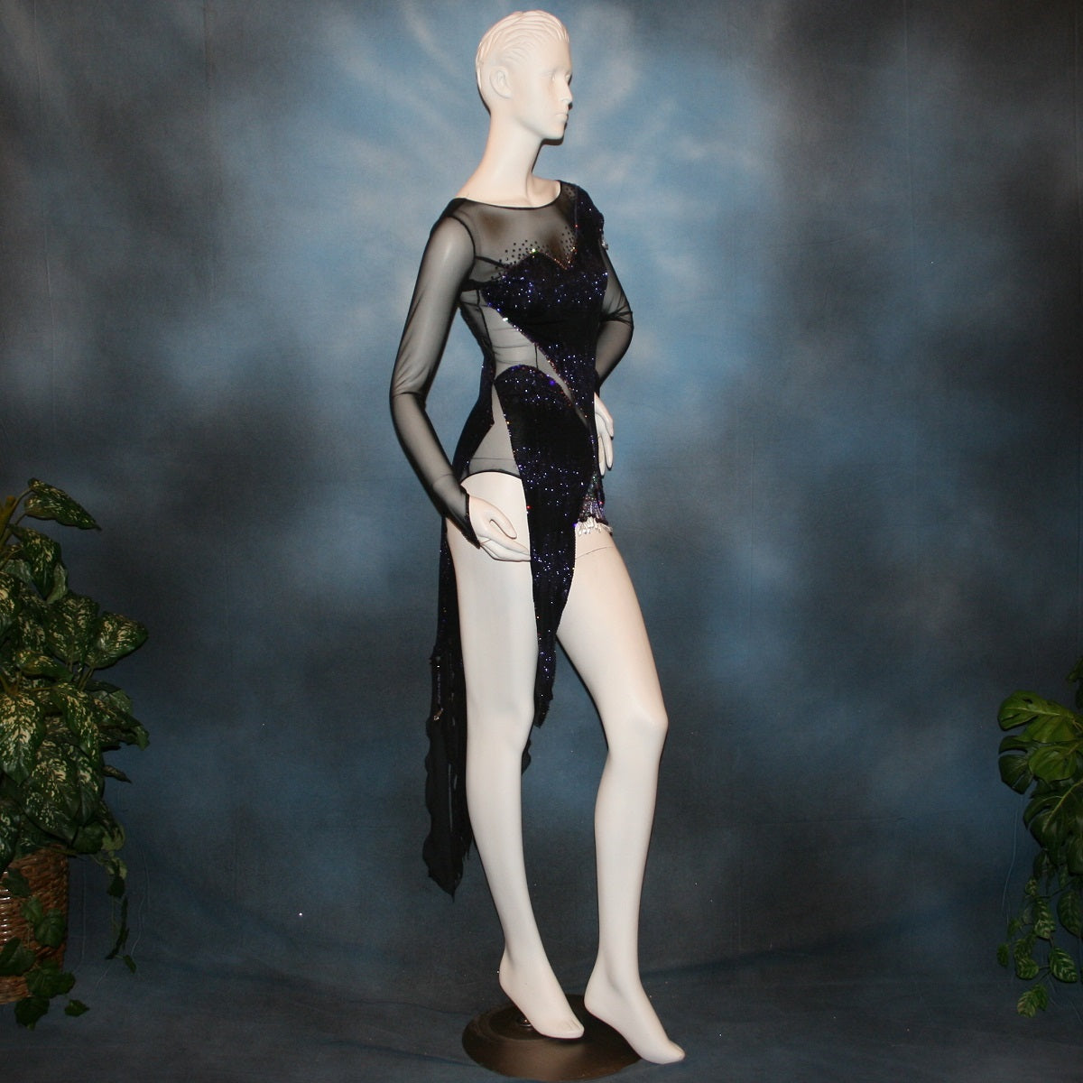 right side view of Crystal's Creations Latin/rhythm/tango dress created in black glitter slinky with an awesome electrifying tanzanite/perwinkle glitter pattern artistically placed on a black stretch mesh base