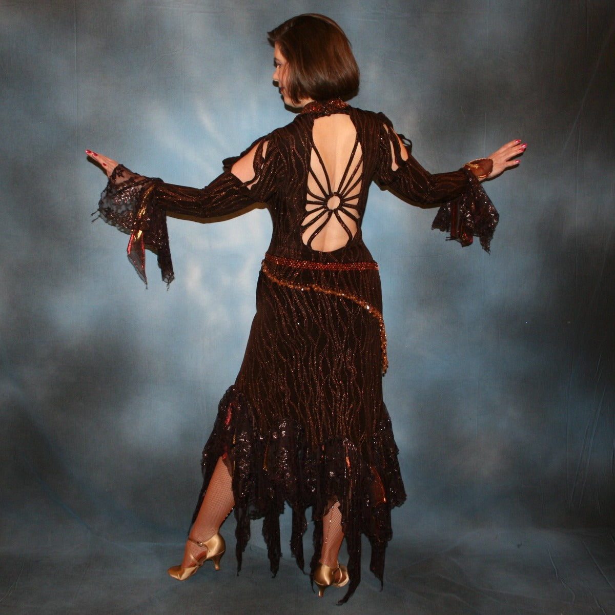 back view of Brown tango dress, bolero dress or rumba dress created in chocolate brown &amp; bronze glitter slinky with chocolate brown metallic lace &amp; metallic tricot flounces is embellished with crystal copper Swarovski rhinestones at neckpiece & hipsash, which also has extensive hand beading.