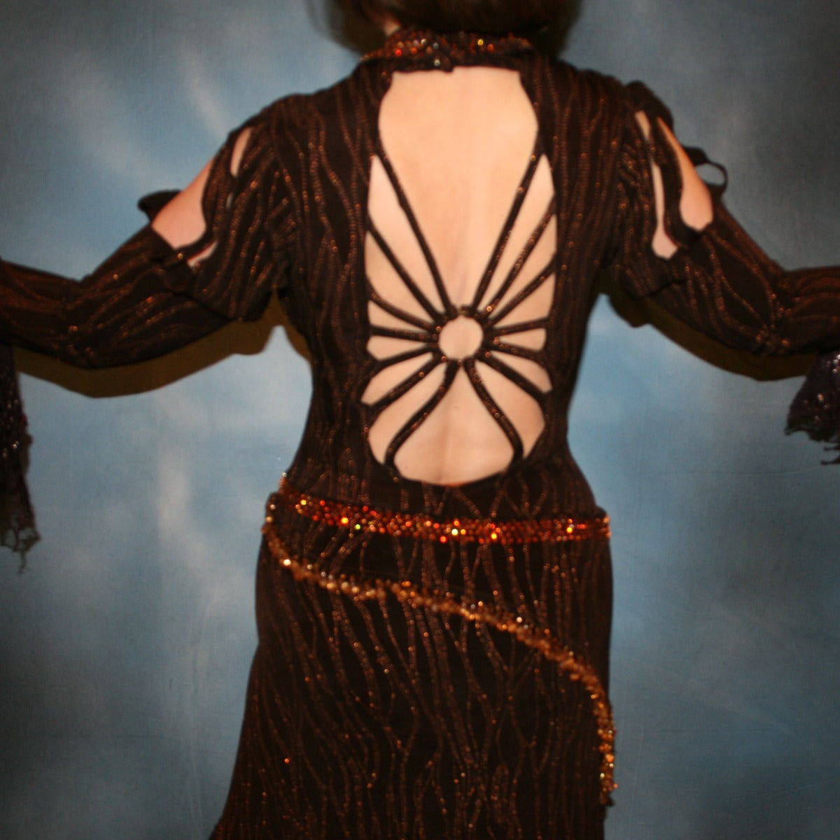 Crystal's Creations close up back view of Brown tango dress, bolero dress or rumba dress created in chocolate brown &amp; bronze glitter slinky with chocolate brown metallic lace &amp; metallic tricot flounces is embellished with crystal copper Swarovski rhinestones at neckpiece & hipsash, which also has extensive hand beading.