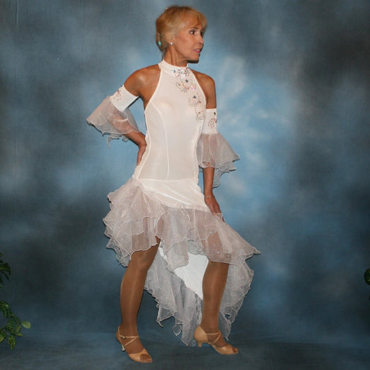 Crystal's Creations White Latin/rhythm dress created in luxurious stretch velvet, features fancy organza flounces with delicate pink & blue bubble pearlized flocking, embellished with Swarovski rhinestone work, plus hand beading.