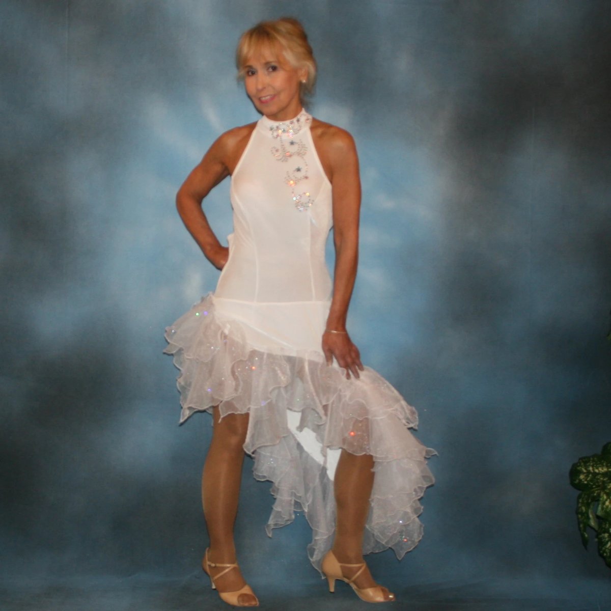 Crystal's Creations White Latin/rhythm dress created in luxurious stretch velvet, features fancy organza flounces with delicate pink & blue bubble pearlized flocking, embellished with Swarovski rhinestone work, plus hand beading.