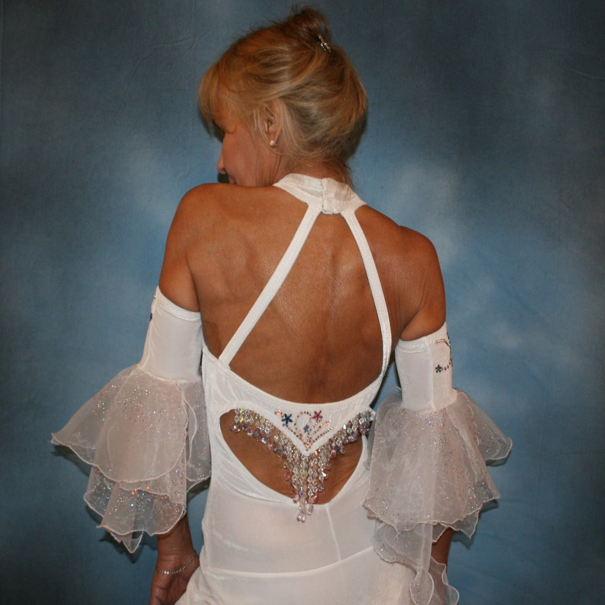 Crystal's Creations close back view of White Latin/rhythm dress created in luxurious stretch velvet, features fancy organza flounces with delicate pink & blue bubble pearlized flocking, embellished with Swarovski rhinestone work, plus hand beading.