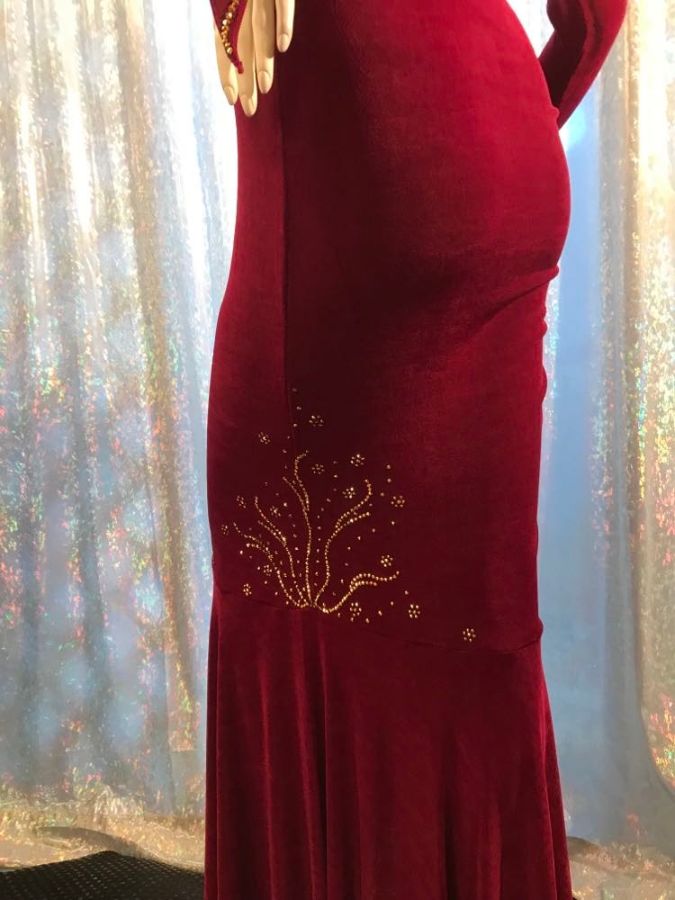 Crystal's Creations bottom detail view of Magenta Latin/rhythm/tango dress created out of deep magenta/wine slinky features ruching, long flared sleeves & is embellished with gold aurum Swarovski rhinestone work with a bit of Swarovski bead detail on back strap