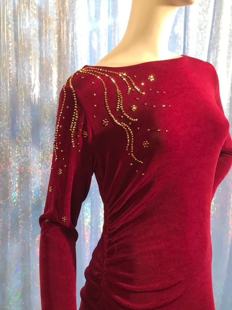 Crystal's Creations upper view of Magenta Latin/rhythm/tango dress created out of deep magenta/wine slinky features ruching, long flared sleeves & is embellished with gold aurum Swarovski rhinestone work with a bit of Swarovski bead detail on back strap