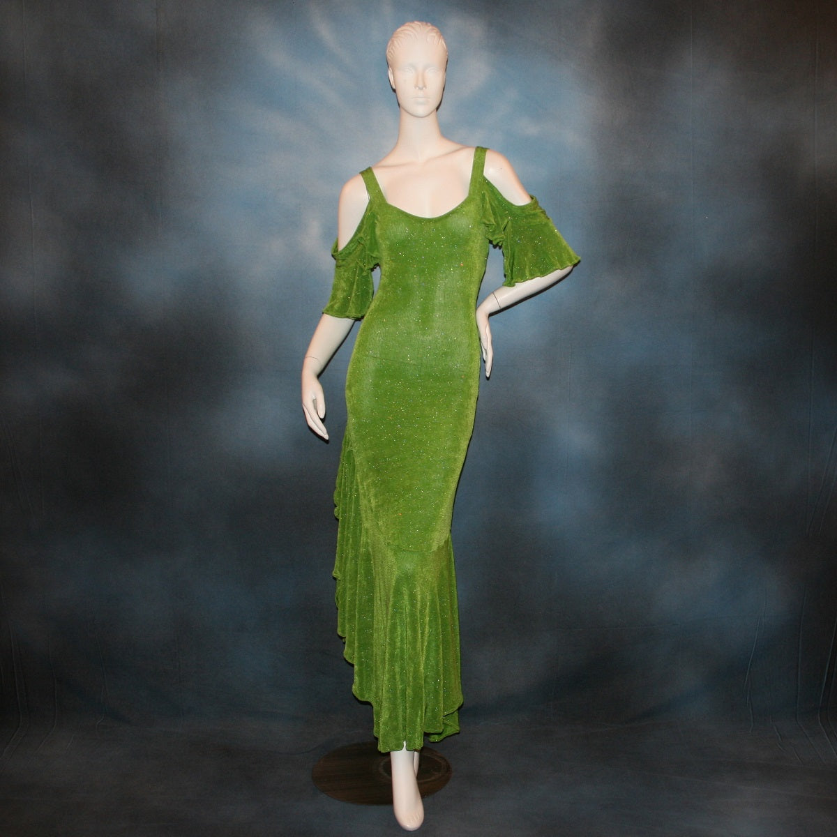 Apple green social Latin/rhythm/tango dress created of apple green glitter slinky with full flared bottom skirting & cold shoulder petal flounce sleeves.