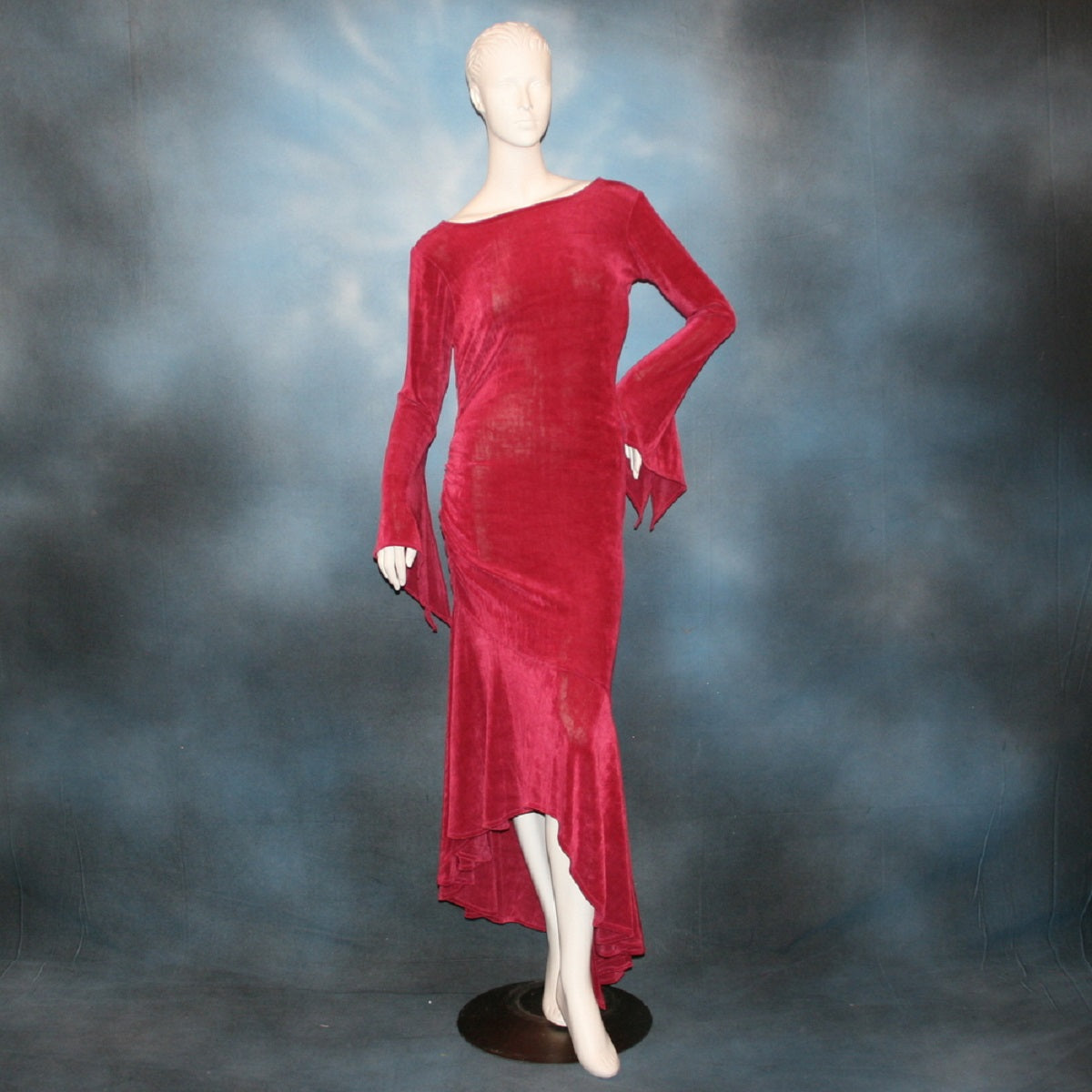 Deep rose Latin/rhythm/social dress created of luxurious deep rose slinky features ruching up the right side & long sleeves with an open flared detail.