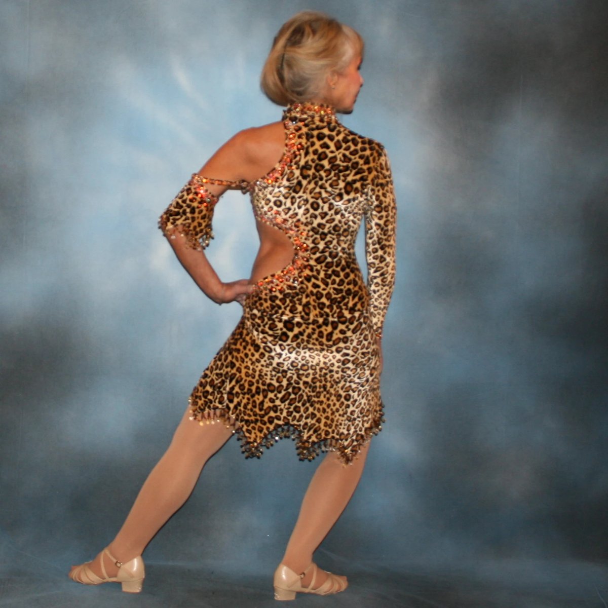 back view of Cheetah print stretch velvet Latin/rhythm dance dress is embellished with about 10 gross of Topaz Ab Swarovski rhinestones & hand beading at skirt bottom & arm band.