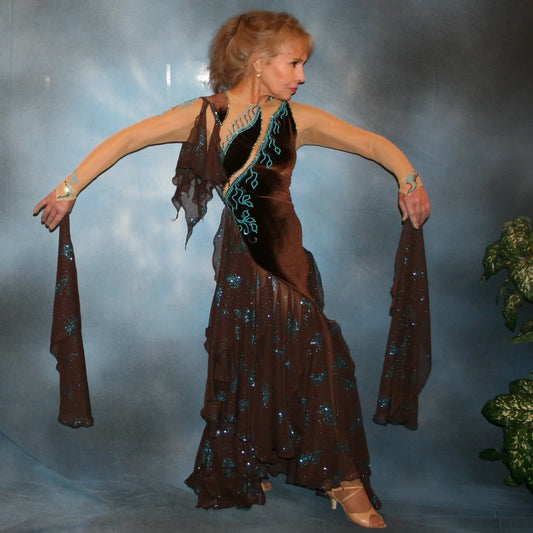 Exquisite brown ballroom dance dress with turquoise accents was created in luxurious chocolate brown stretch velvet on a nude illusion base…featuring billowing yards of brown chiffon petal panels with glittery turquoise butterflies.