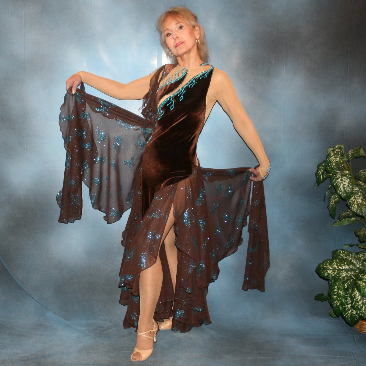 Crystal's Creations Exquisite brown ballroom dance dress with turquoise accents was created in luxurious chocolate brown stretch velvet on a nude illusion base…featuring billowing yards of brown chiffon petal panels with glittery turquoise butterflies. 