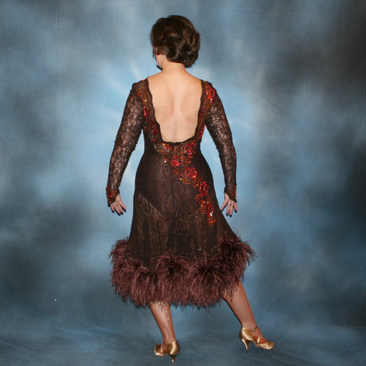 Crystal's Creations back view of Chocolate brown Latin/rhythm dance dress of stretch lace lavished with detailed Swarovski stonework done in Indian pink* & crystal copper… with ostrich feathers adorning the skirt edge…and includes under bodysuit.