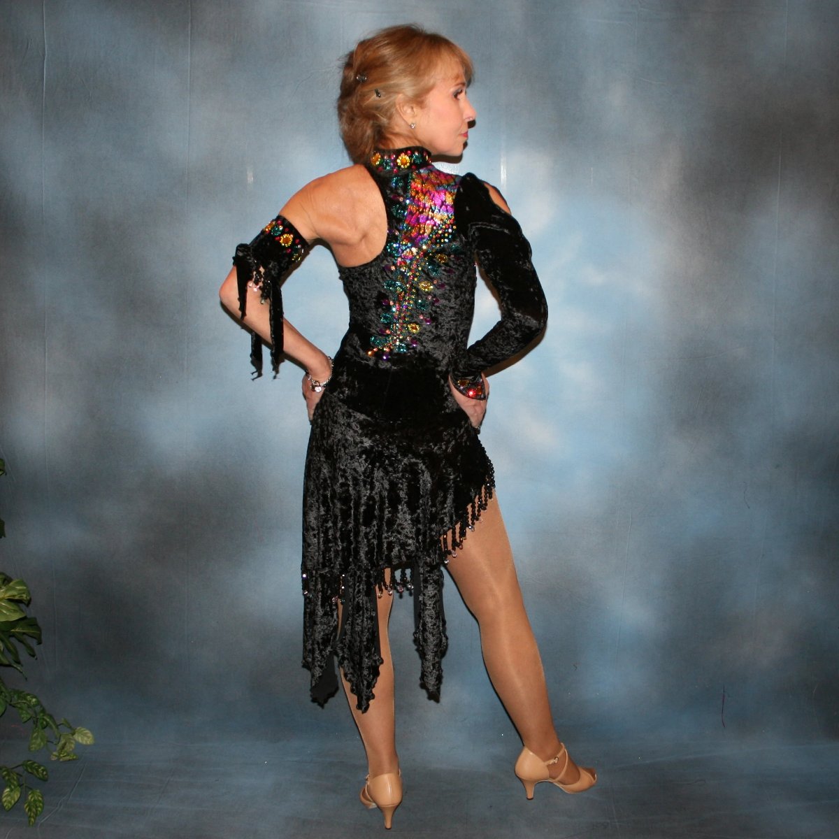 back view of Black Latin/rhythm dress created in black panne velvet with colorful confetti hologram lycra accents, is embellished with hand beading, Swarovski CAB, citrine, & blue zircon rhinestones plus large colorful acrylic gems.