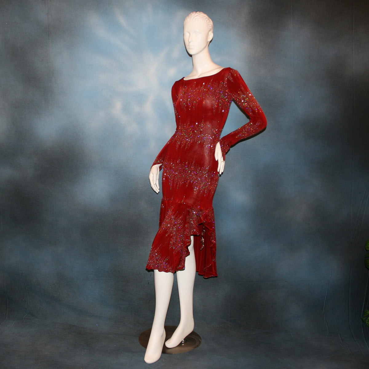 Deep scarlette red Latin/rhythm/tango dress created in glitter slinky with an awesome electrifying glitter pattern features lattice detailing in the back, long sleeves with Swarovski hand beading in the skirt sides.