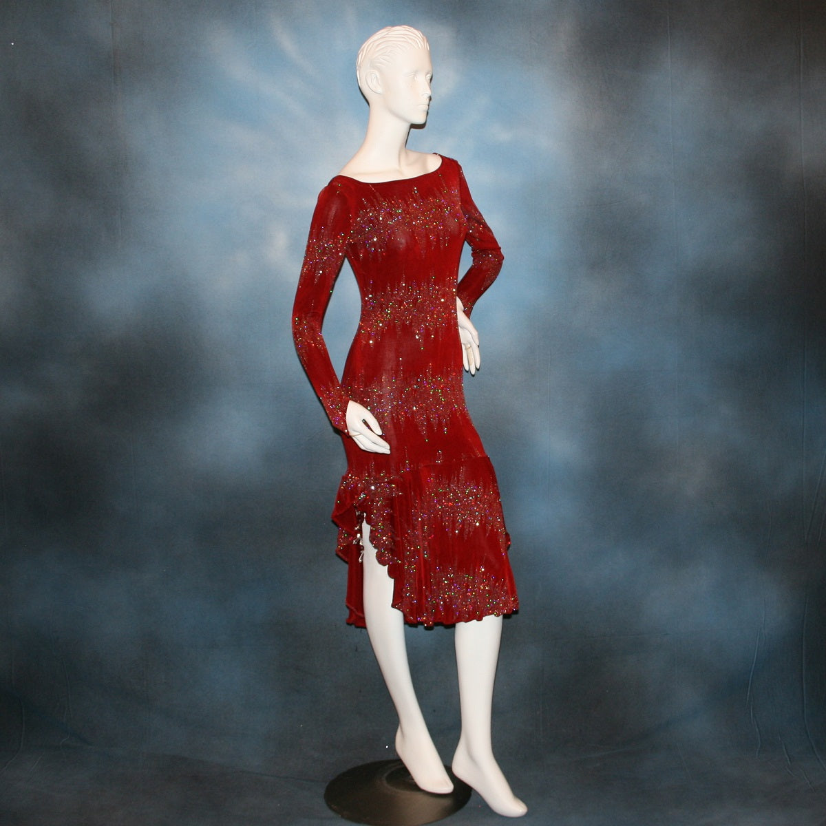side view of Deep scarlette red Latin/rhythm/tango dress created in glitter slinky with an awesome electrifying glitter pattern features lattice detailing in the back, long sleeves with Swarovski hand beading in the skirt sides.