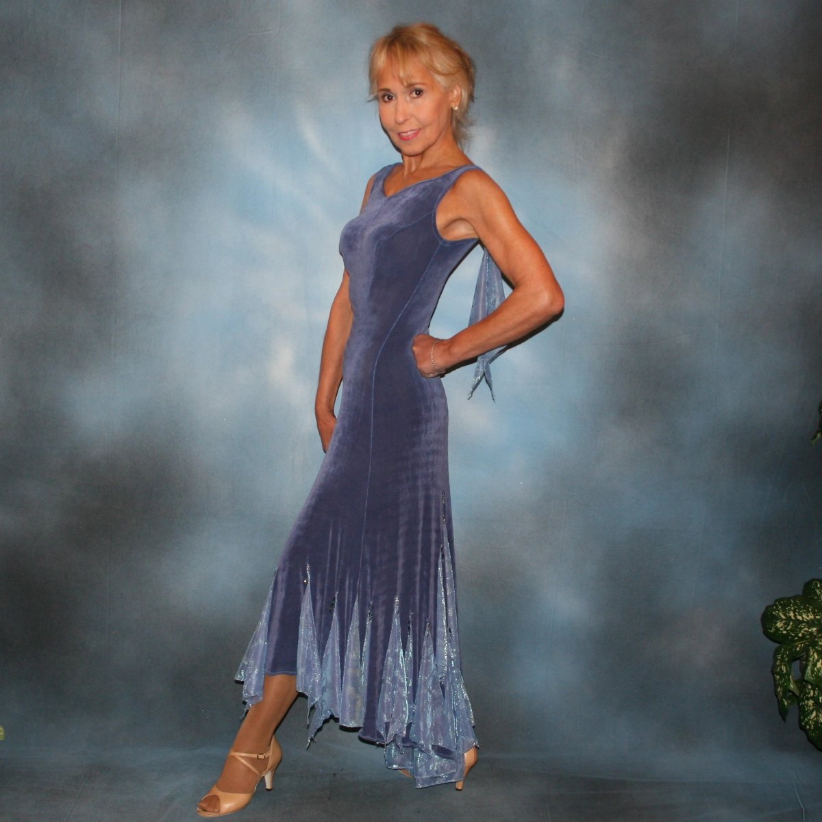 Crystal's Creations side view of Beautiful slate blue classic ballroom dress with princess seaming, created in luxurious solid slinky with iridescent insets, flounces & small floats, embellished with Swarovski hand beading. Lovely as is for any ballroom dance, social event or beginner show dance dress